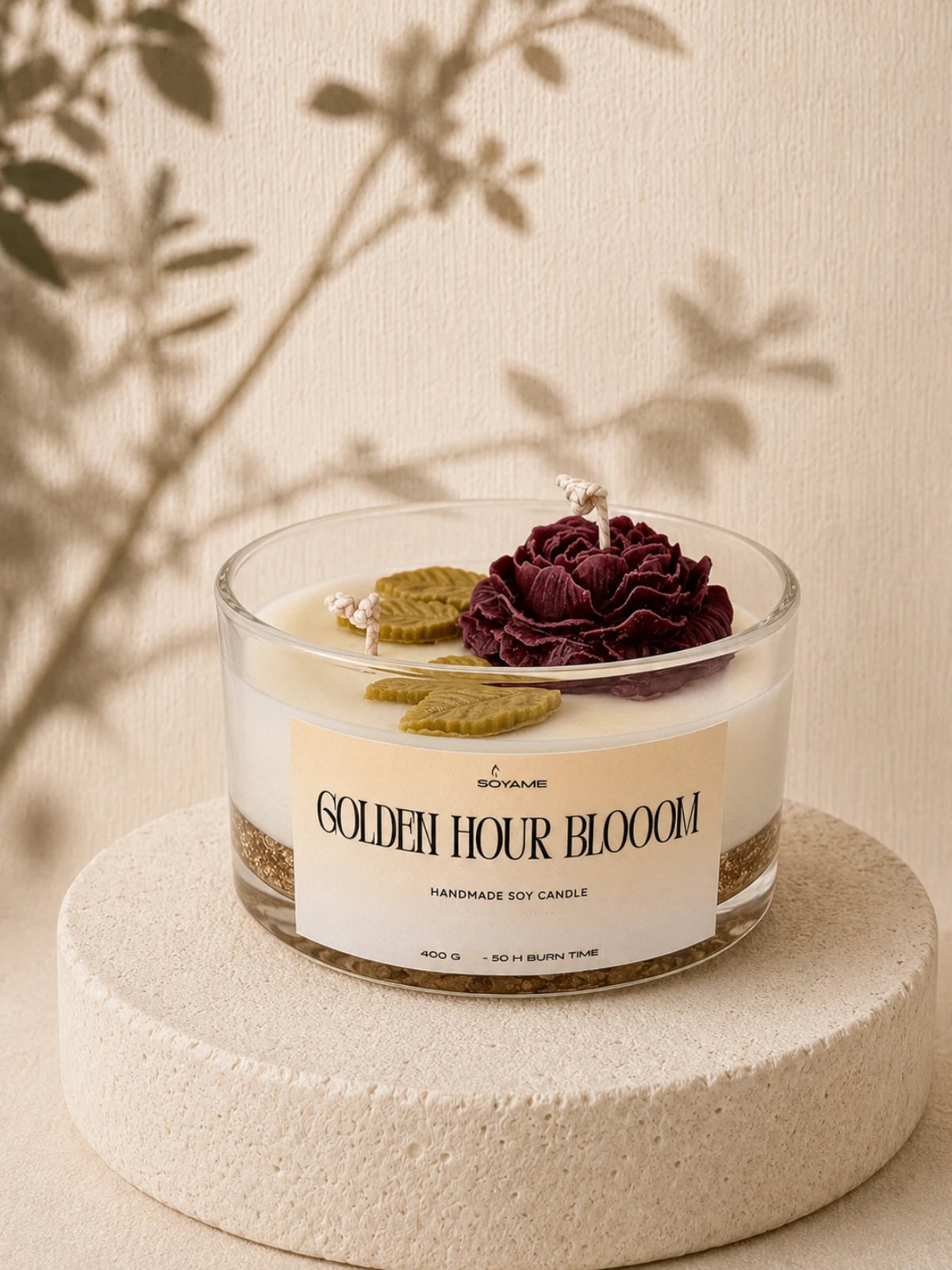 Golden Hour Bloom handmade soy candle with a burgundy flower in a glass jar