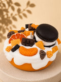 Orange Crush cake-inspired pillar candle decorated with orange and chocolate-coloured wax sweets