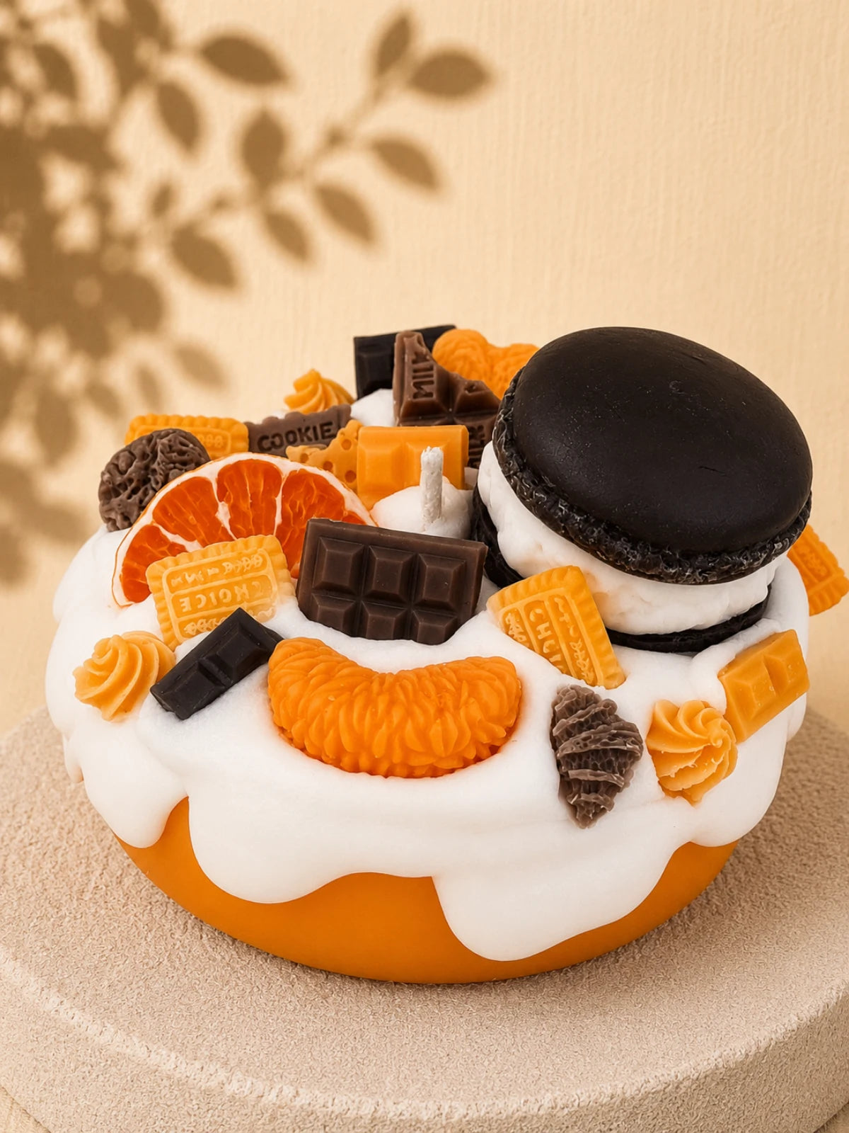 Orange Crush cake-inspired pillar candle decorated with orange and chocolate-coloured wax sweets