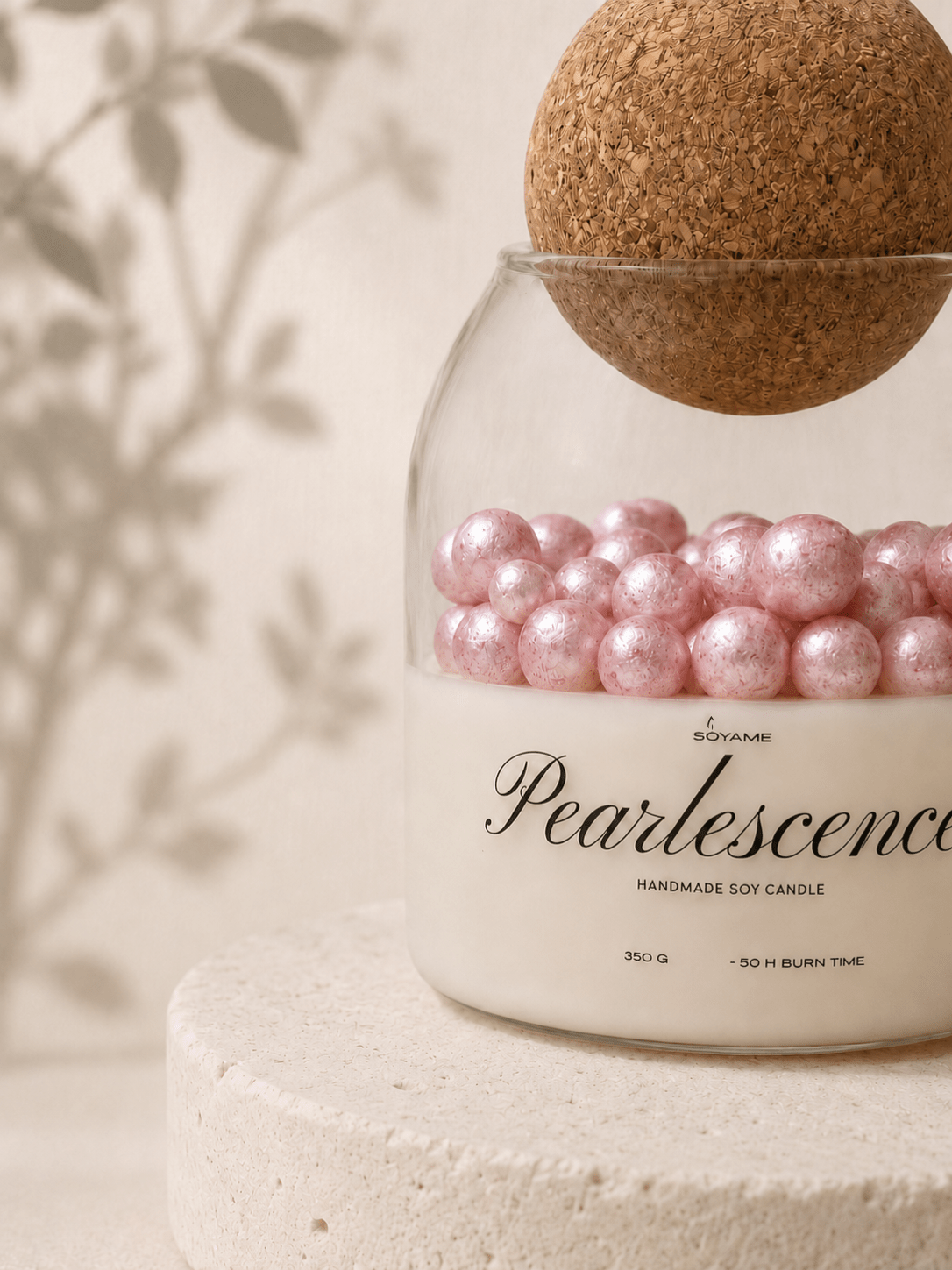 Close-up of Pink Pearlescence scented soy candle with decorative pink pearl wax details