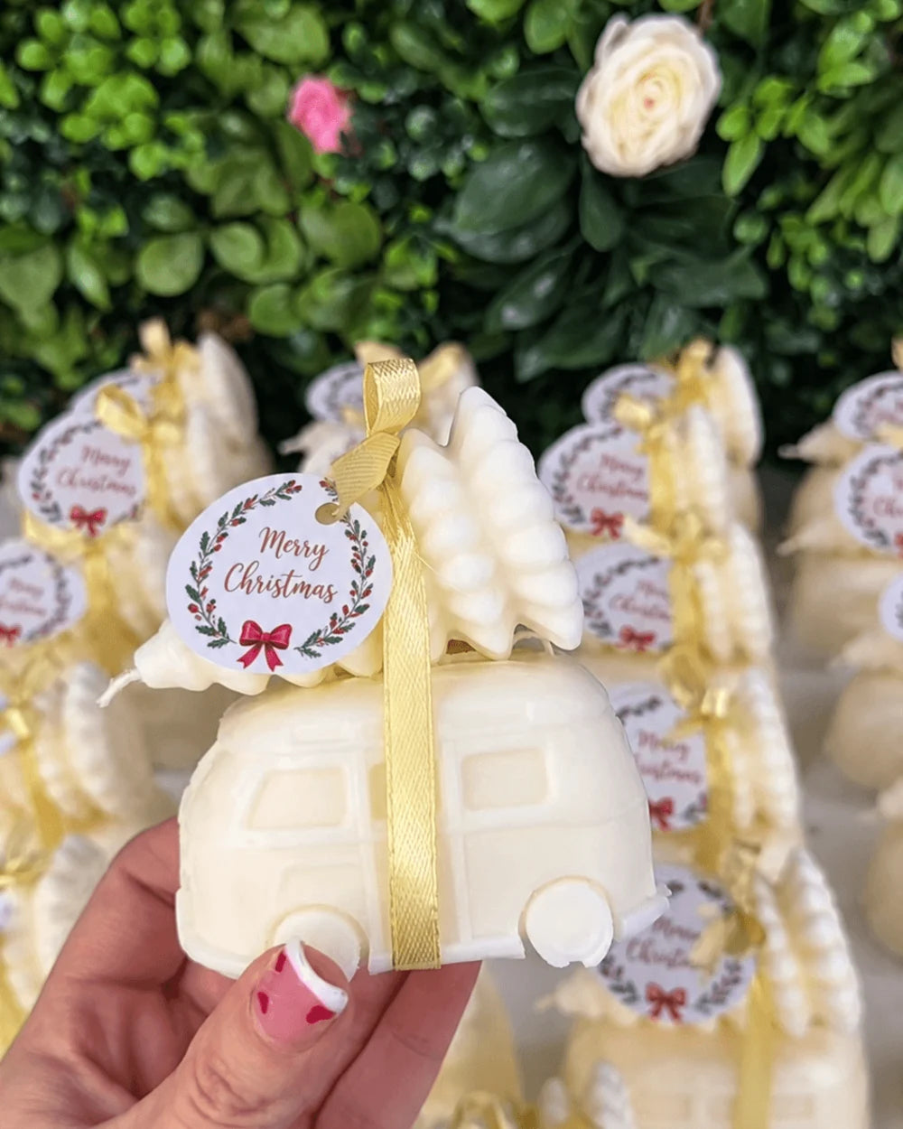 Christmas caravan candle favour with festive tree, gold ribbon and Merry Christmas tag for corporate gifting