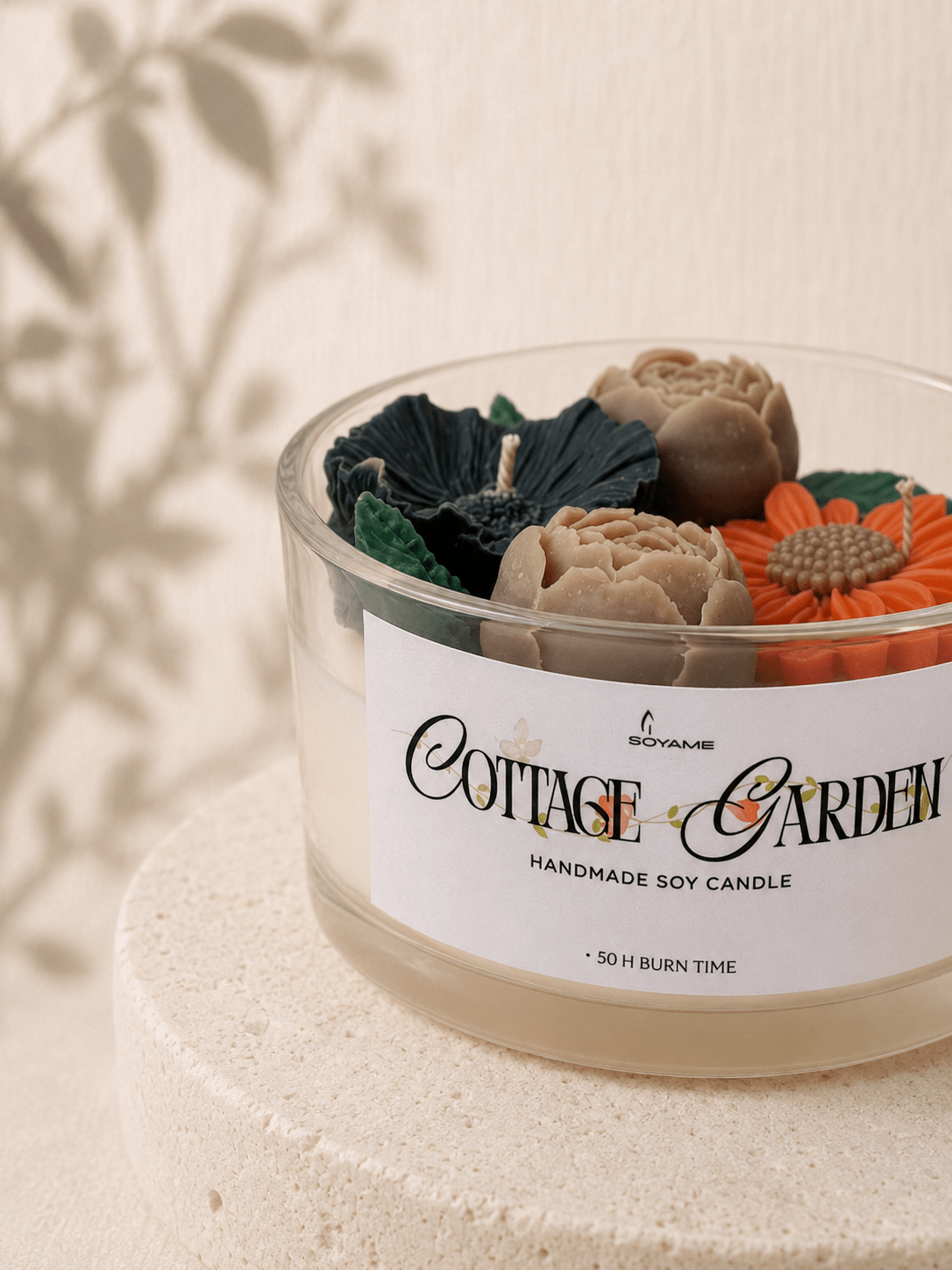 Close-up of Cottage Garden scented soy candle with detailed flower and leaf wax decorations
