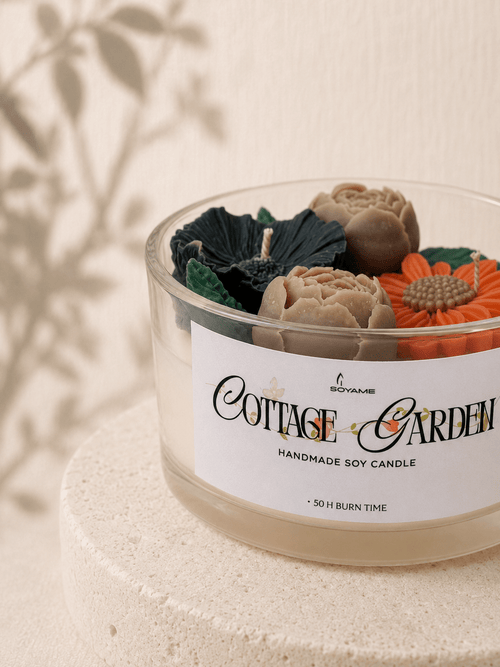 Close-up of Cottage Garden scented soy candle with detailed flower and leaf wax decorations