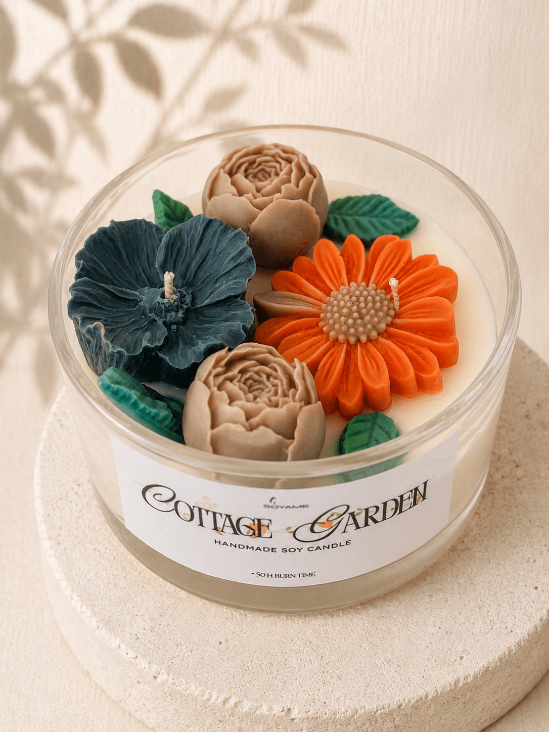 Top view of Cottage Garden scented soy candle with colourful handcrafted wax flowers and green leafs