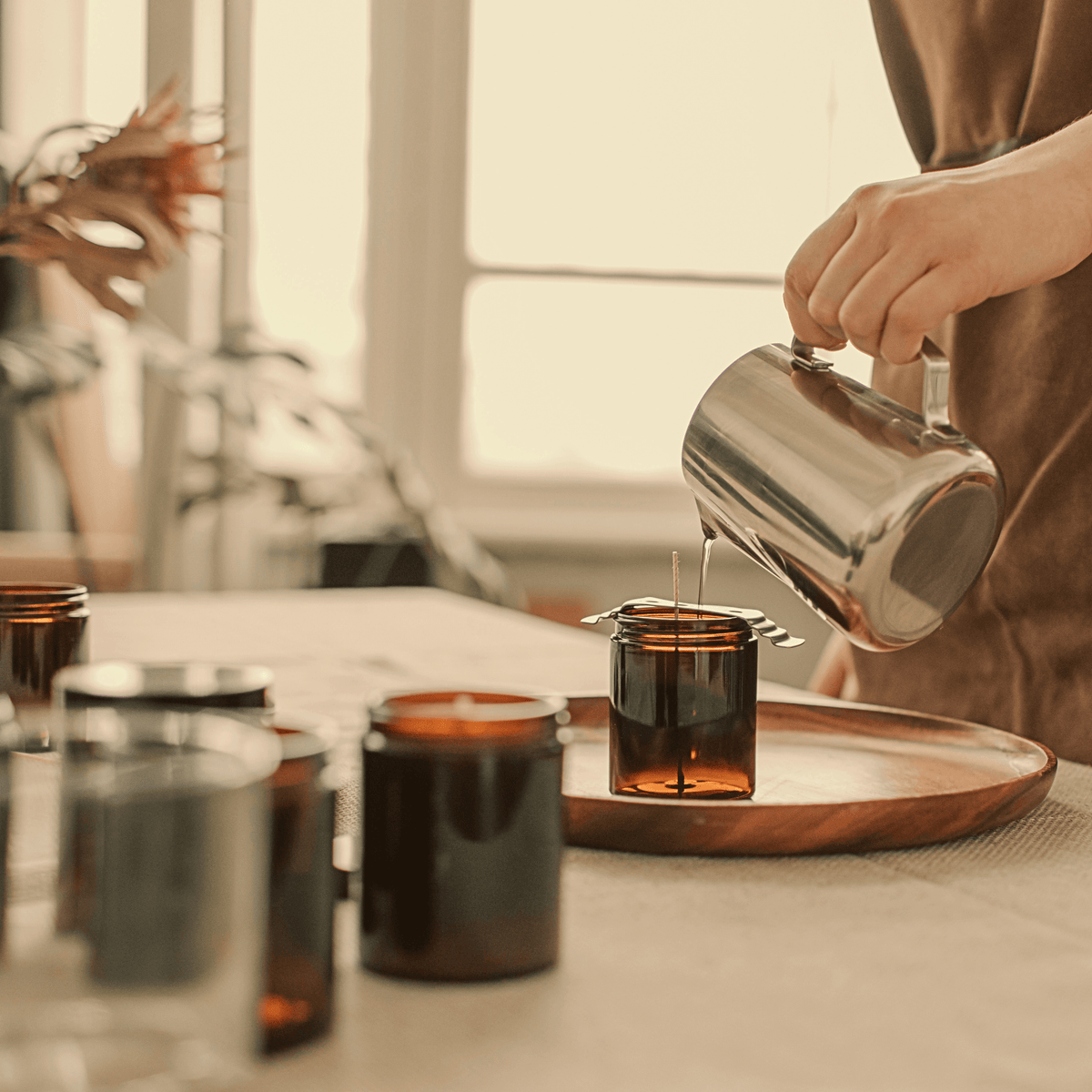 Hand-pouring candles in the SOYAME studio as part of our small-batch candle making process.