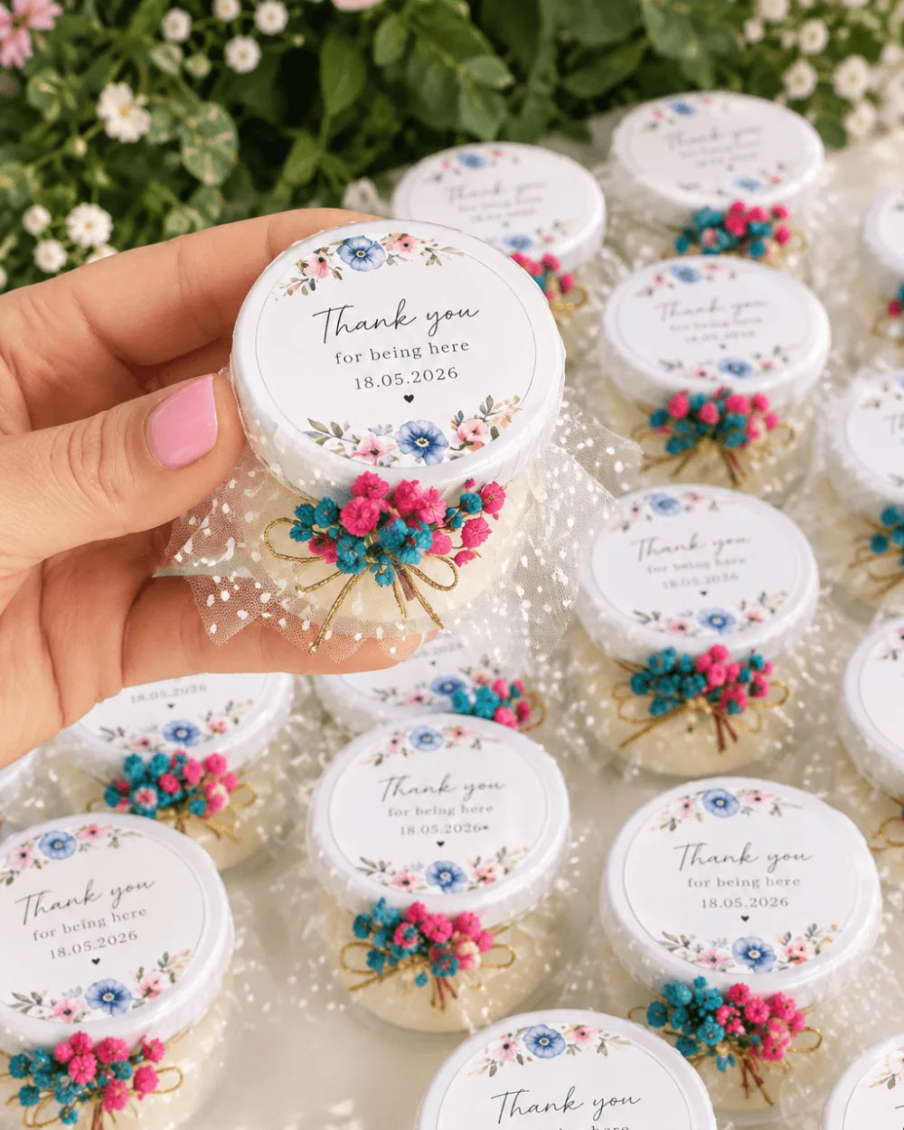 Personalised candle favours with floral thank you labels, white tulle and pink and blue dried flowers
