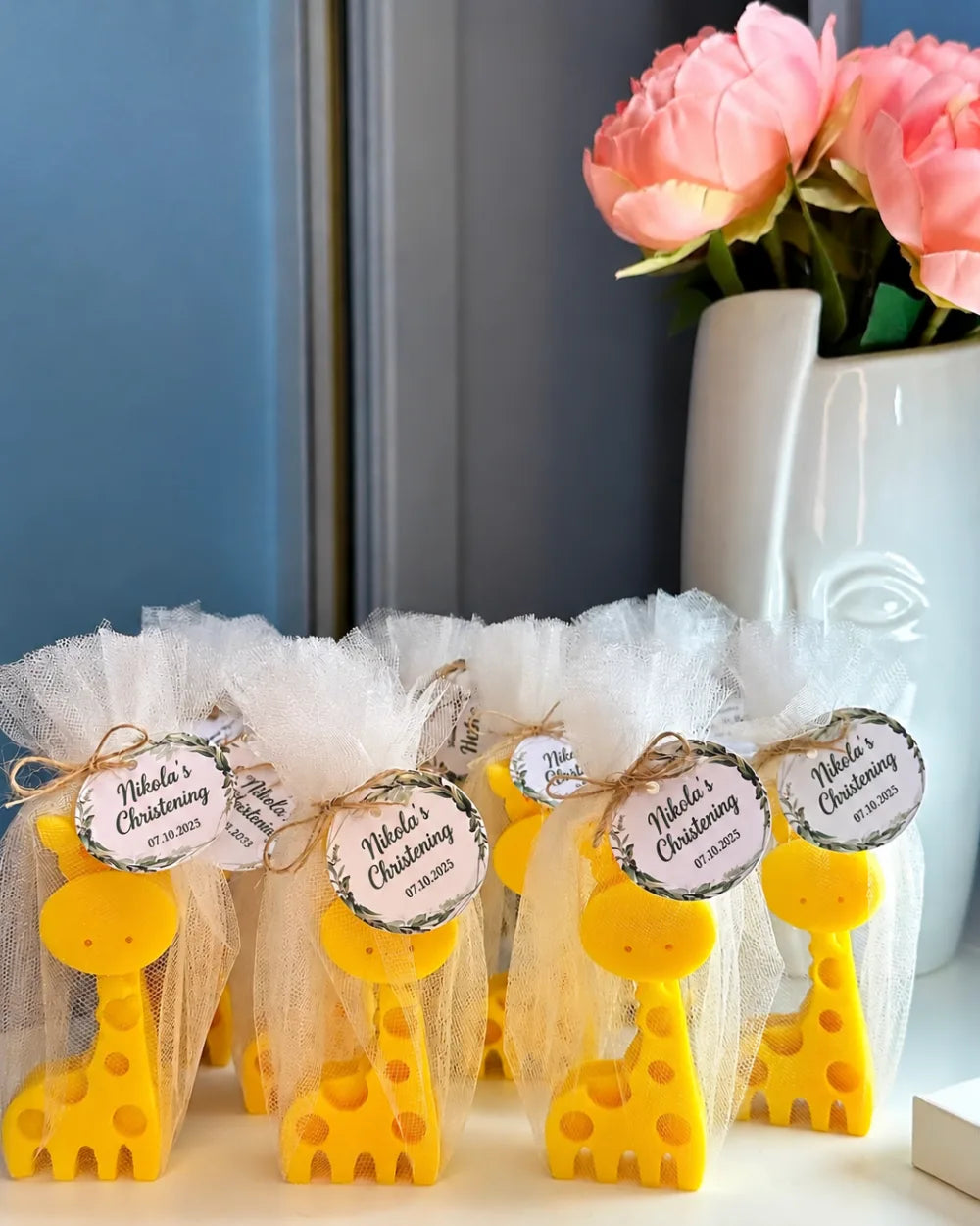 Yellow giraffe candle favours in tulle bags with personalised christening tags
