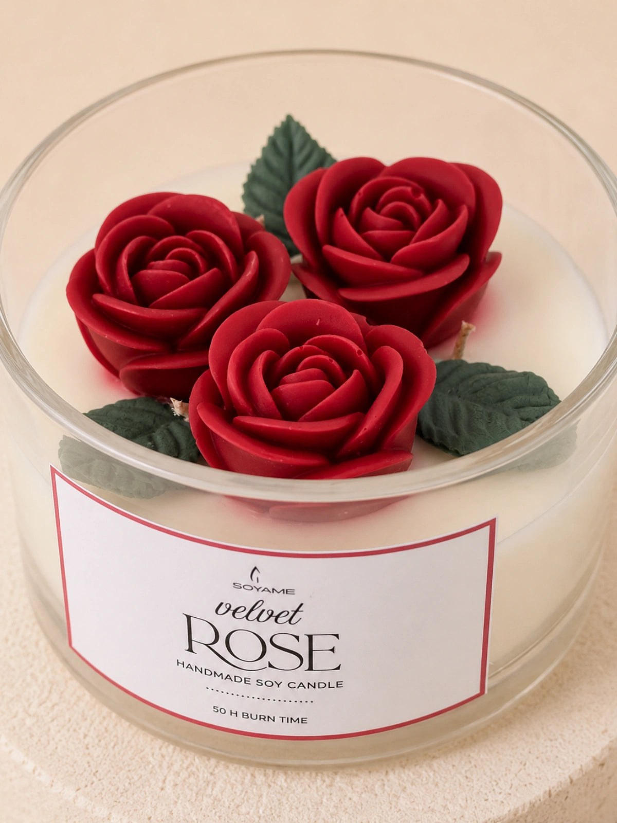 Close-up of Velvet Rose candle with detailed red rose wax decoration